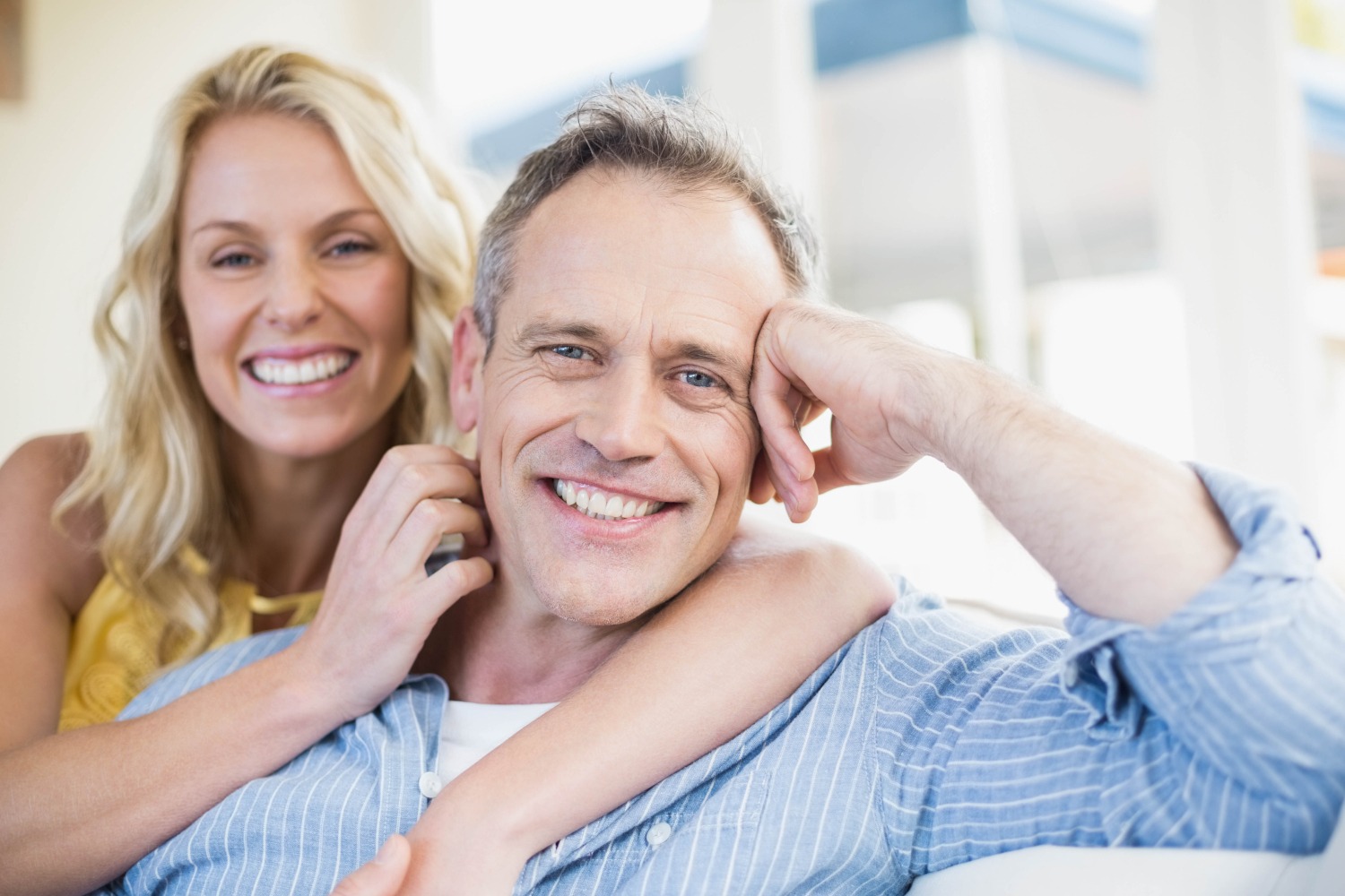 Smiling couple enjoying orthodontic treatment benefits, representing adult orthodontics at Pechersky Orthodontics in Pittsburgh, showcasing confidence and oral health improvement.